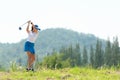 Golfer sport course golf ball fairway. People lifestyle woman playing game golf and swing golf ball go on green grass.ÃÂ  Royalty Free Stock Photo